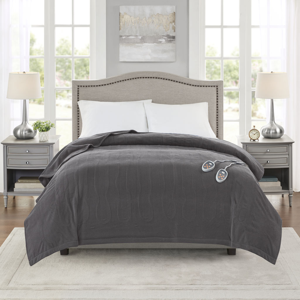 Official Olliix grey micro-fleece blanket staged on a bed with two wired controllers; the same PicPath is returned for BR54-0413 Queen and BR54-0414 King