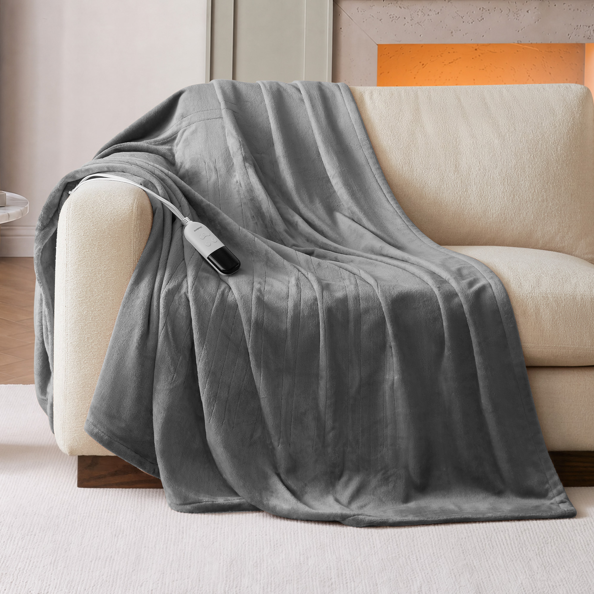 Grey Beautyrest BR54-0529N 60 × 70-inch plush heated throw staged on a chair with a wired digital-style control