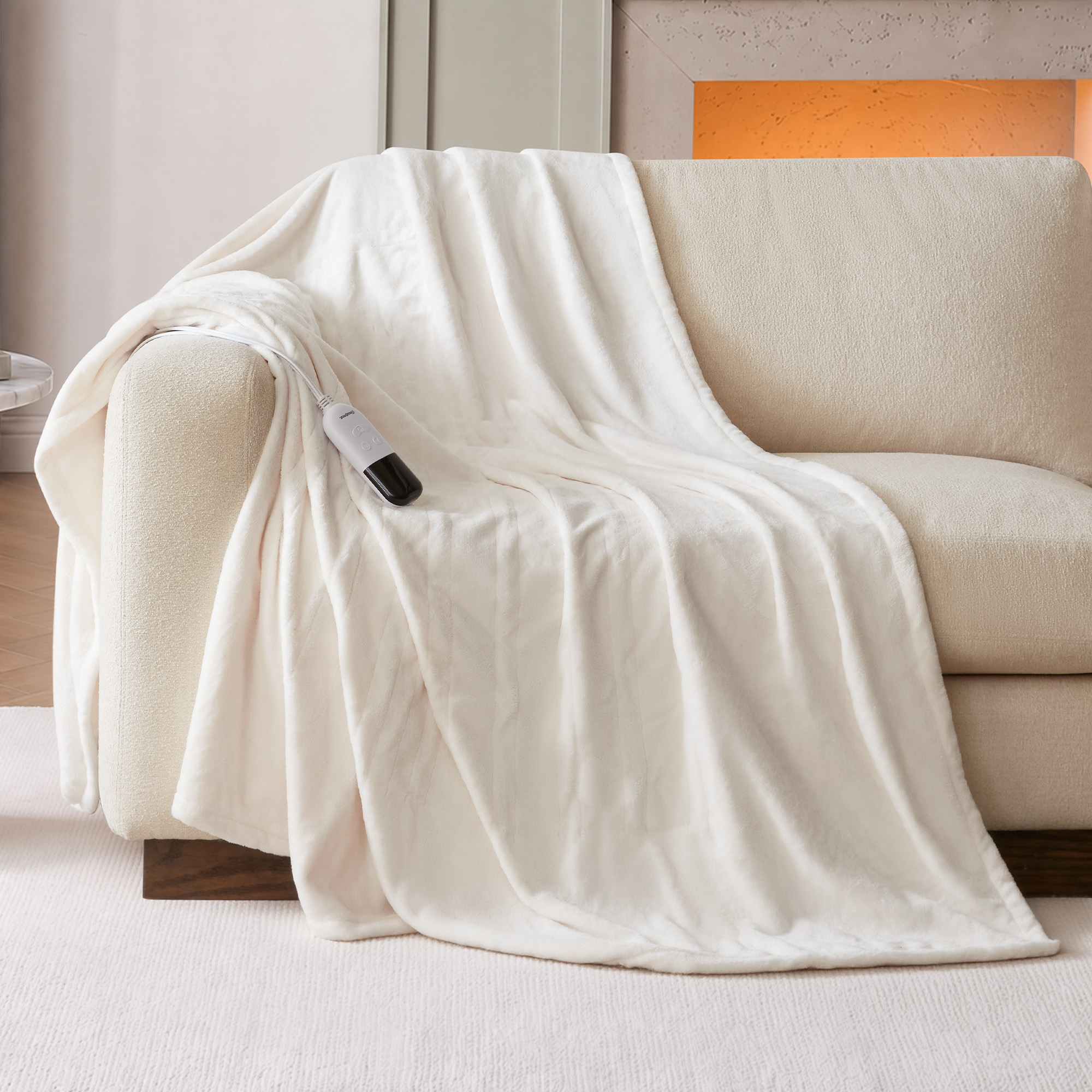 Ivory Beautyrest BR54-0531N 60 × 70-inch plush heated throw staged on a chair with a wired controller