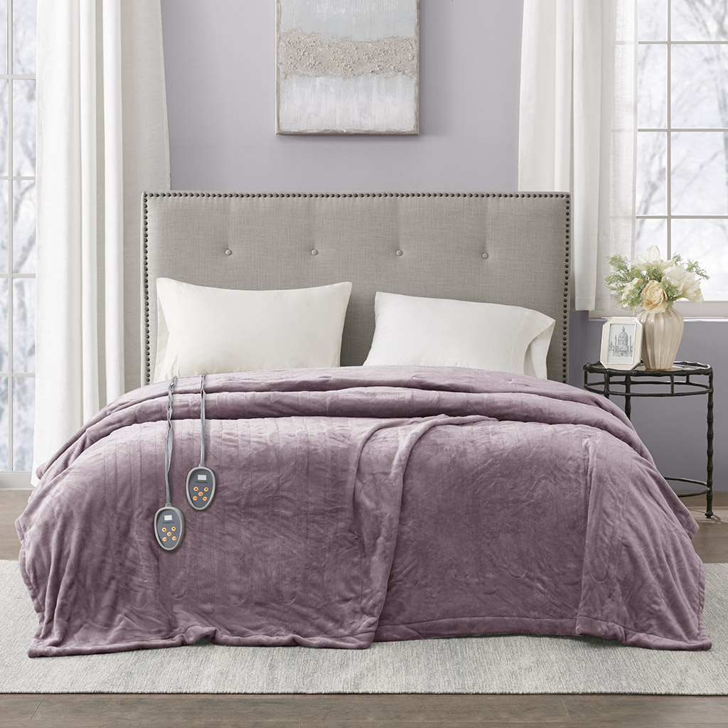 Manufacturer-linked Lavender Beautyrest plush heated blanket shown on a bed with two handset-like controls
