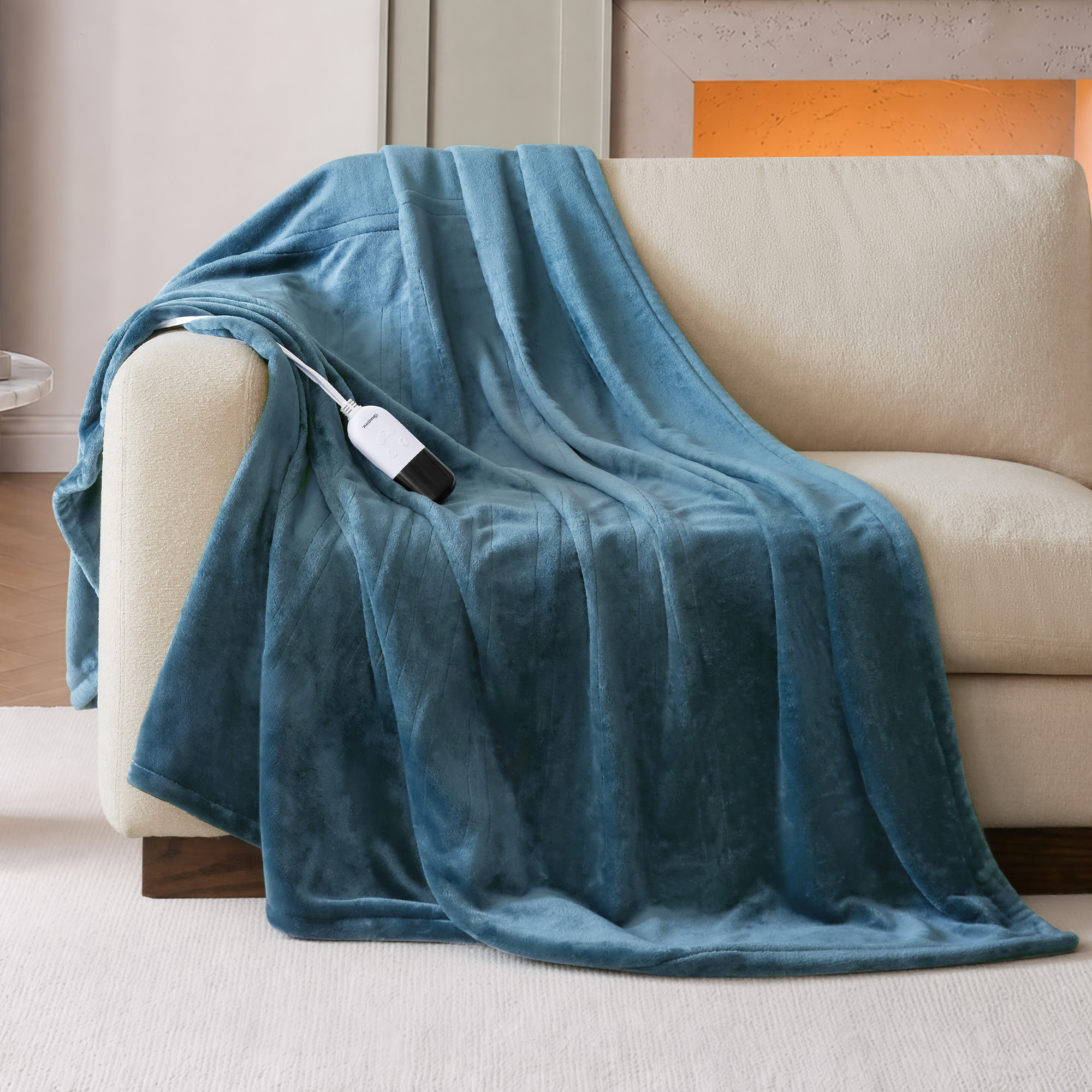 Sapphire Blue Beautyrest BR54-0664N 60 × 70-inch plush heated throw staged on a chair with a wired controller