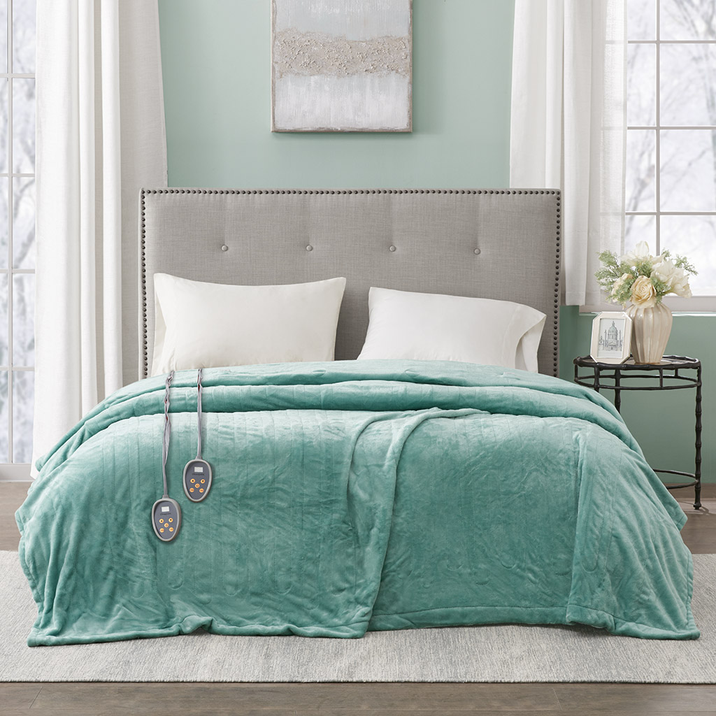 Aqua-looking Beautyrest plush blanket spread over a bed with two wired handsets in the Olliix image associated with BR54-0906