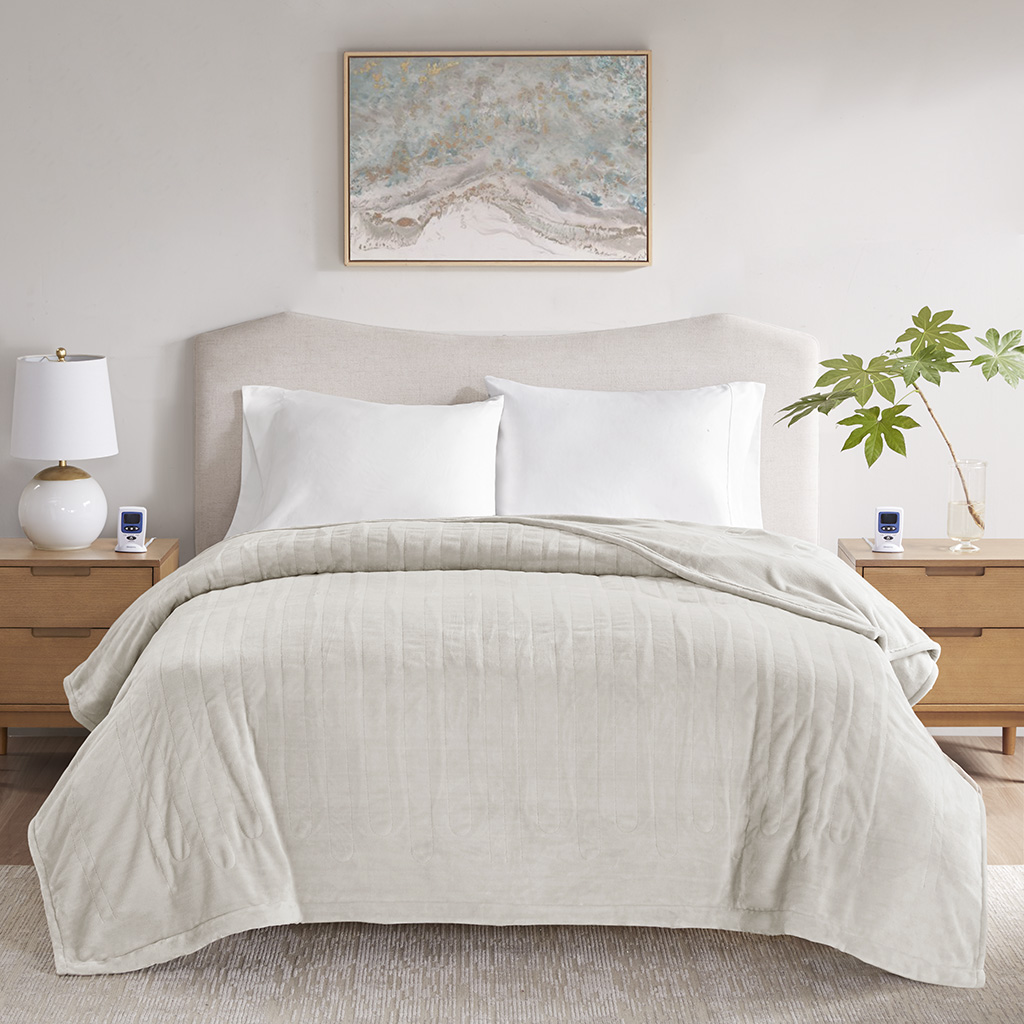 Ivory Beautyrest BR54-4126 connected heated blanket staged on a bed with two controllers