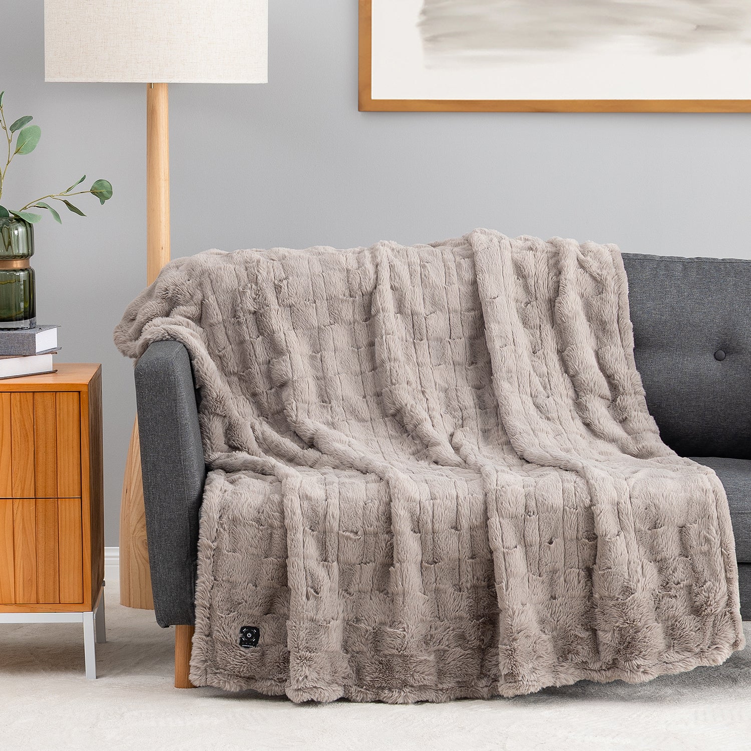 Wild Dove E0819 Berkshire Heated Faux Fur Throw draped over a sofa, showing its raised channel pattern