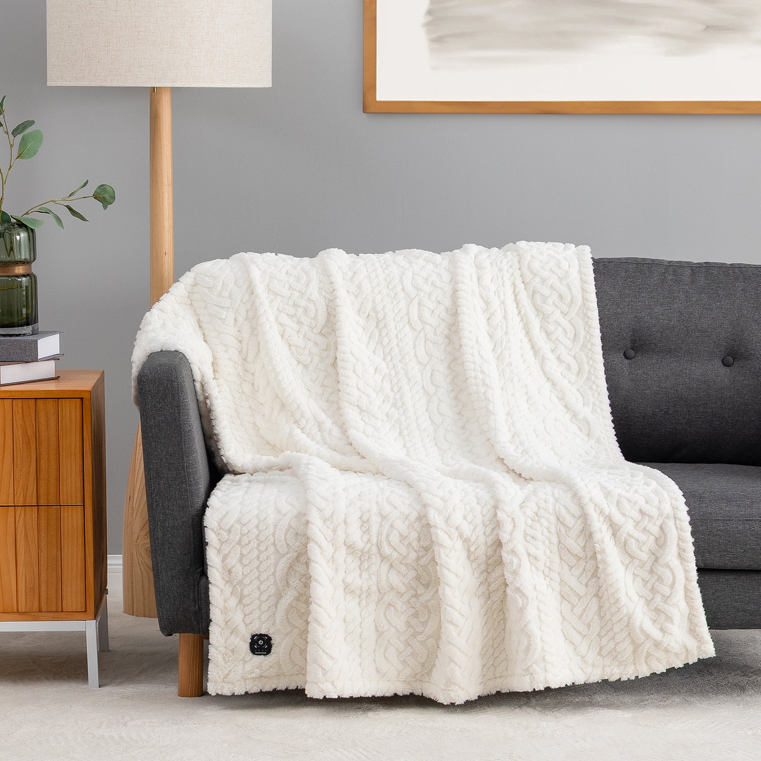 Cream E0820 Berkshire Heated Faux Fur Throw draped over a sofa