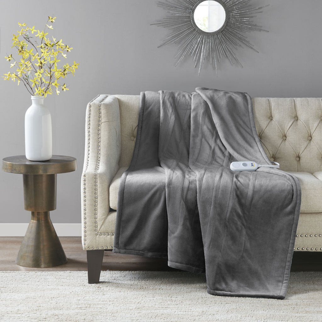 Serta ST54-0074 dark-gray-looking heated throw draped over a chair with one wired controller