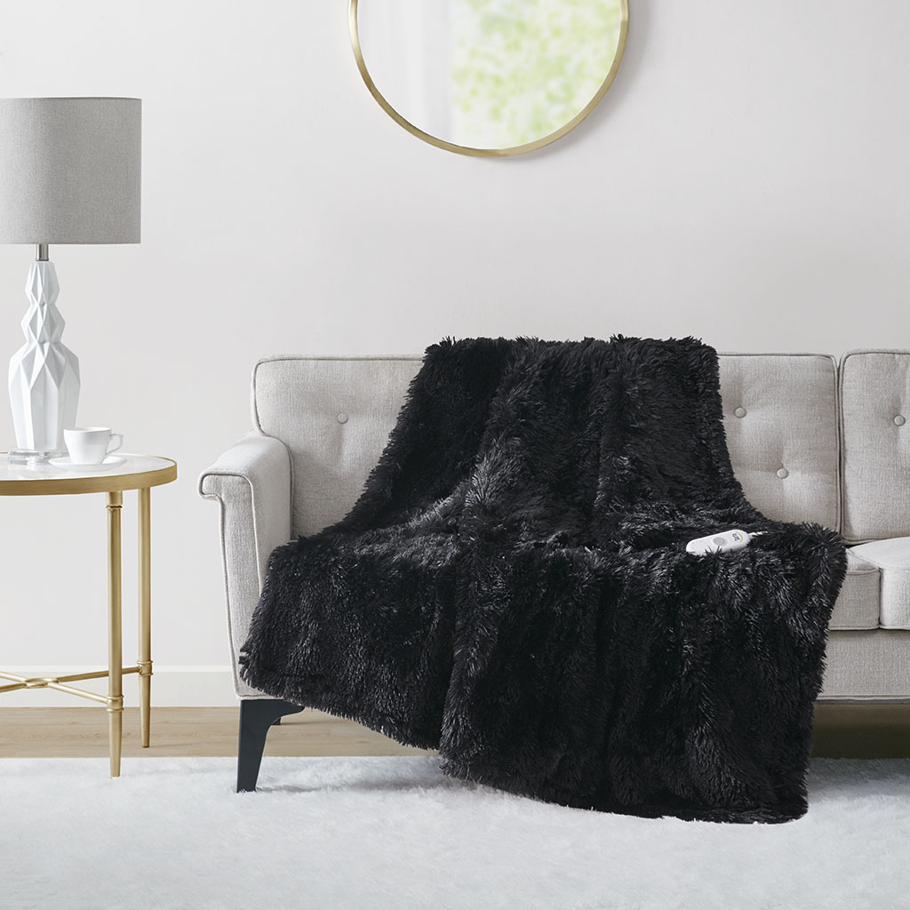 Official Serta Malea Black ST54-0153 50 × 60 in shaggy faux-fur heated throw staged on a sofa with one controller