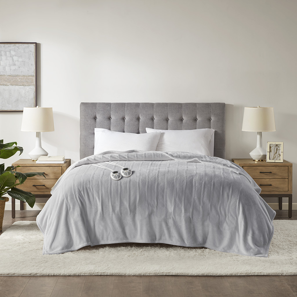 Light Grey Serta Plush Heated Blanket staged on a bed