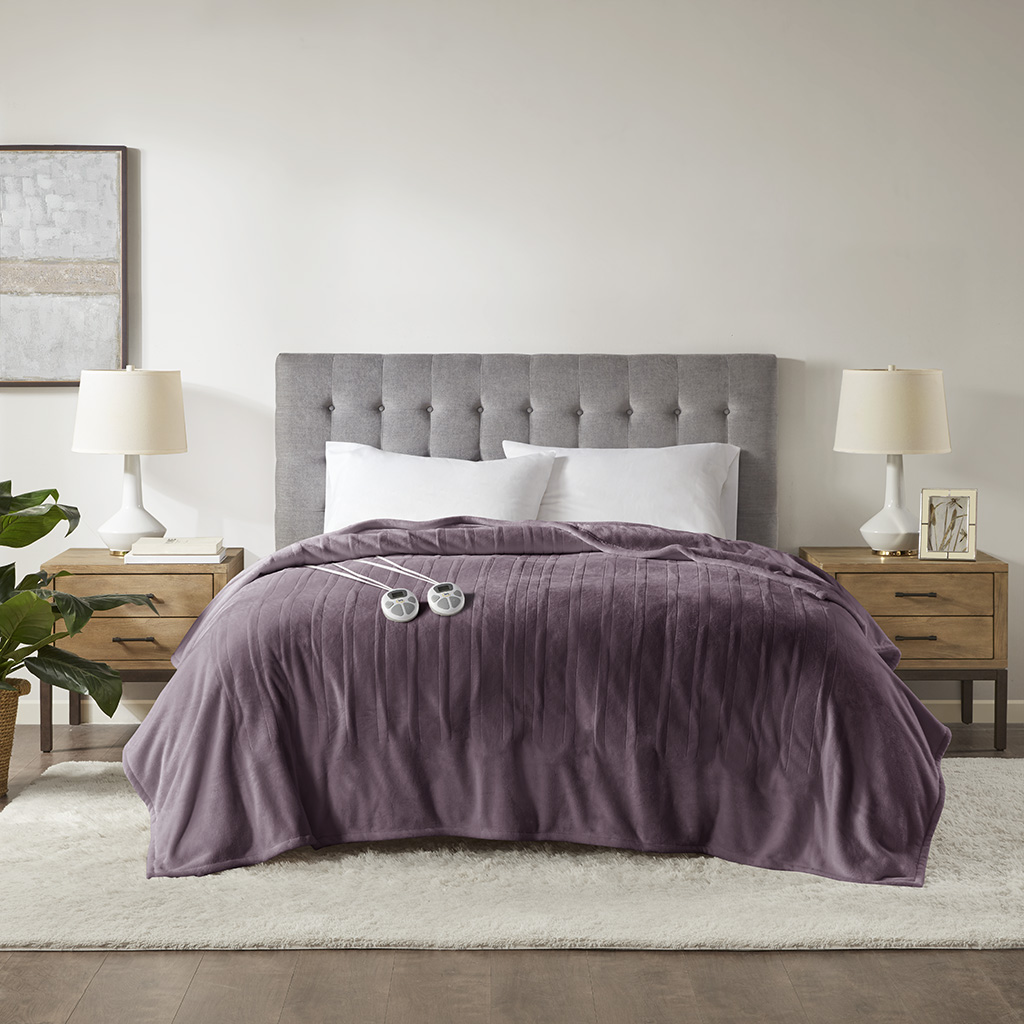 Purple Serta Plush Heated Blanket staged on a bed