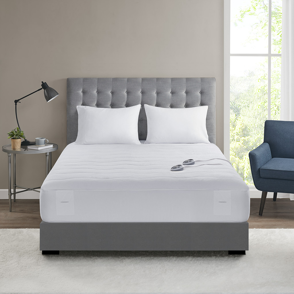 Serta Plush heated mattress pad family illustration; white quilted pad with two handset controllers. The exact Twin dimensions and controller package are not established by this shared image.