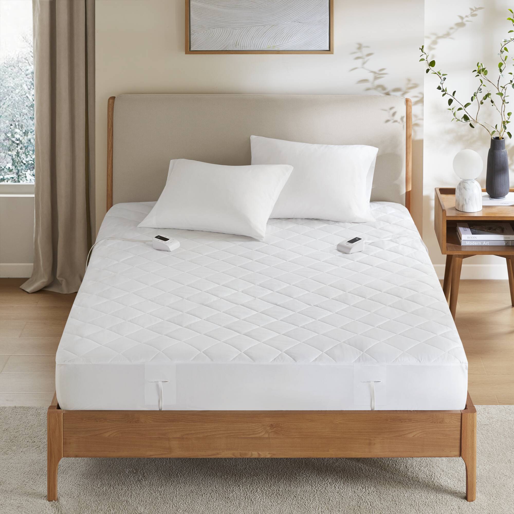 Serta manufacturer image linked to the Full, Queen, King and California King white zoned heated mattress-pad item records, showing two handsets