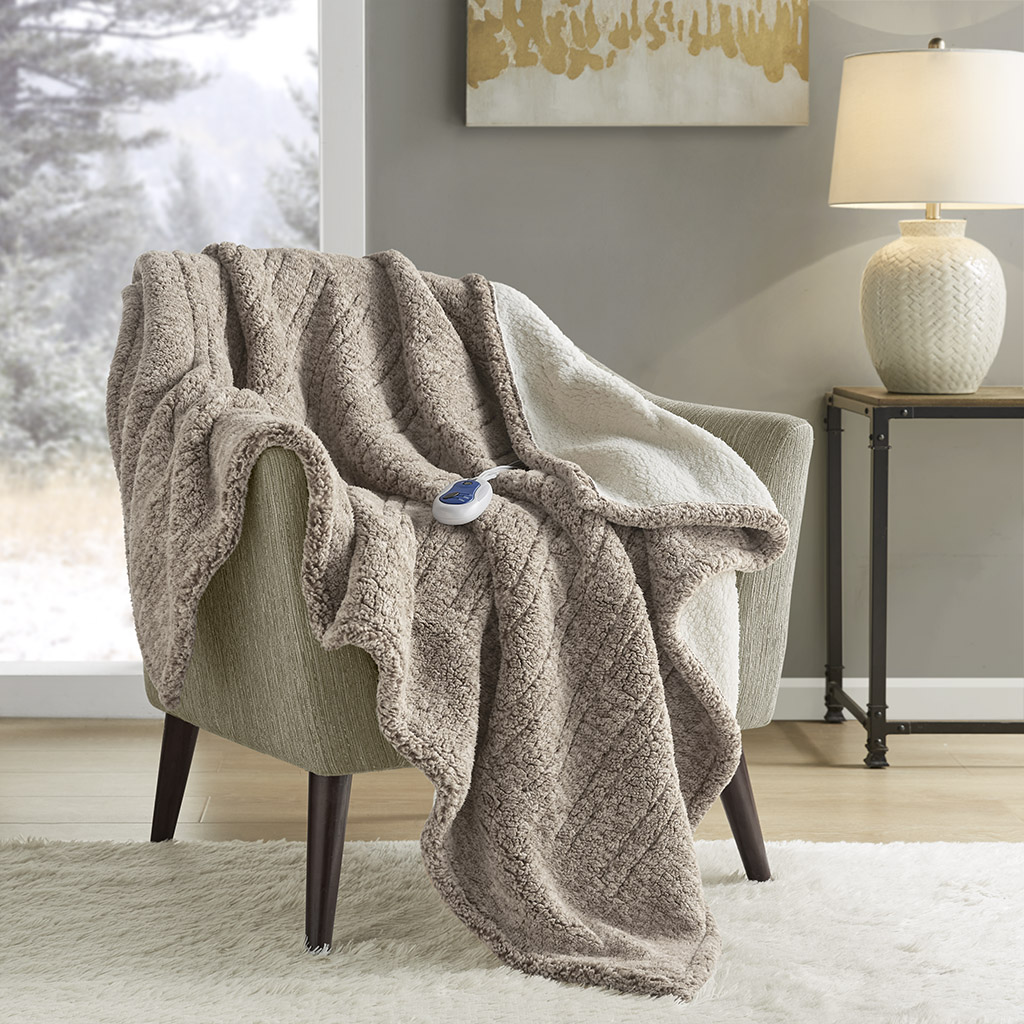 Official Grey True North TN54-0508 heated throw draped over a chair