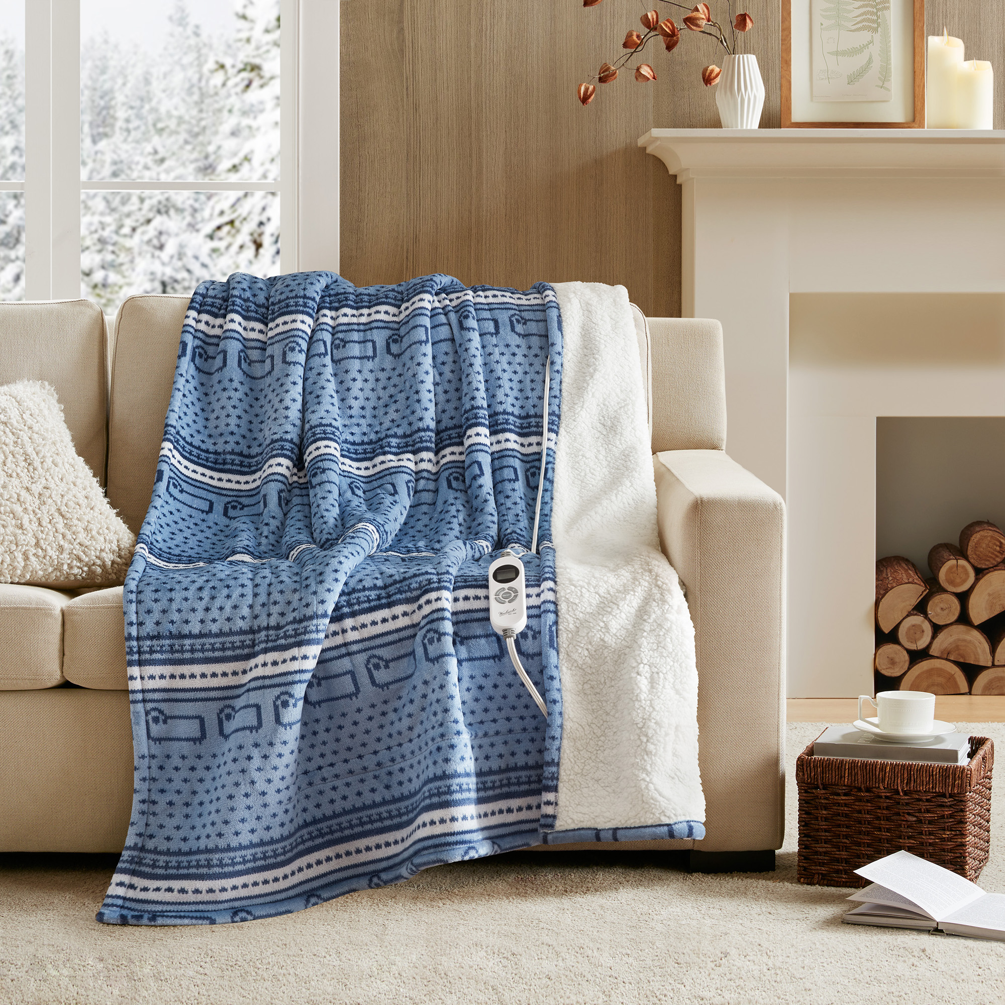 Woolrich WR54-4138 Blue Cozy Sheep 50 by 60 inch heated throw, print-plush face and ivory sherpa reverse; one wired controller is visible.