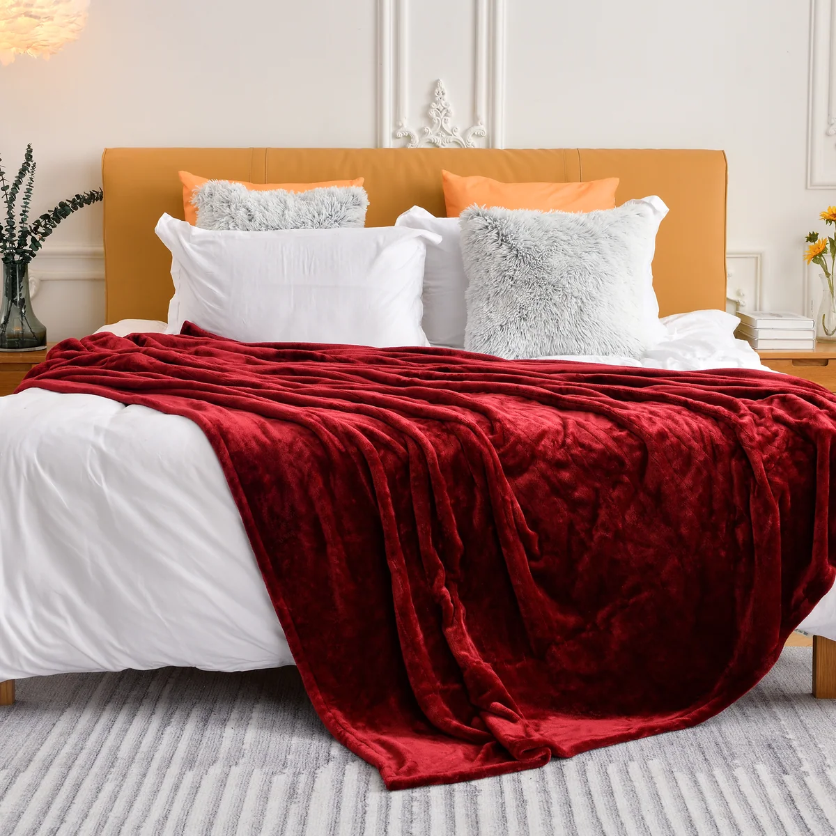 WOOMER-linked Burgundy blanket draped across a made bed