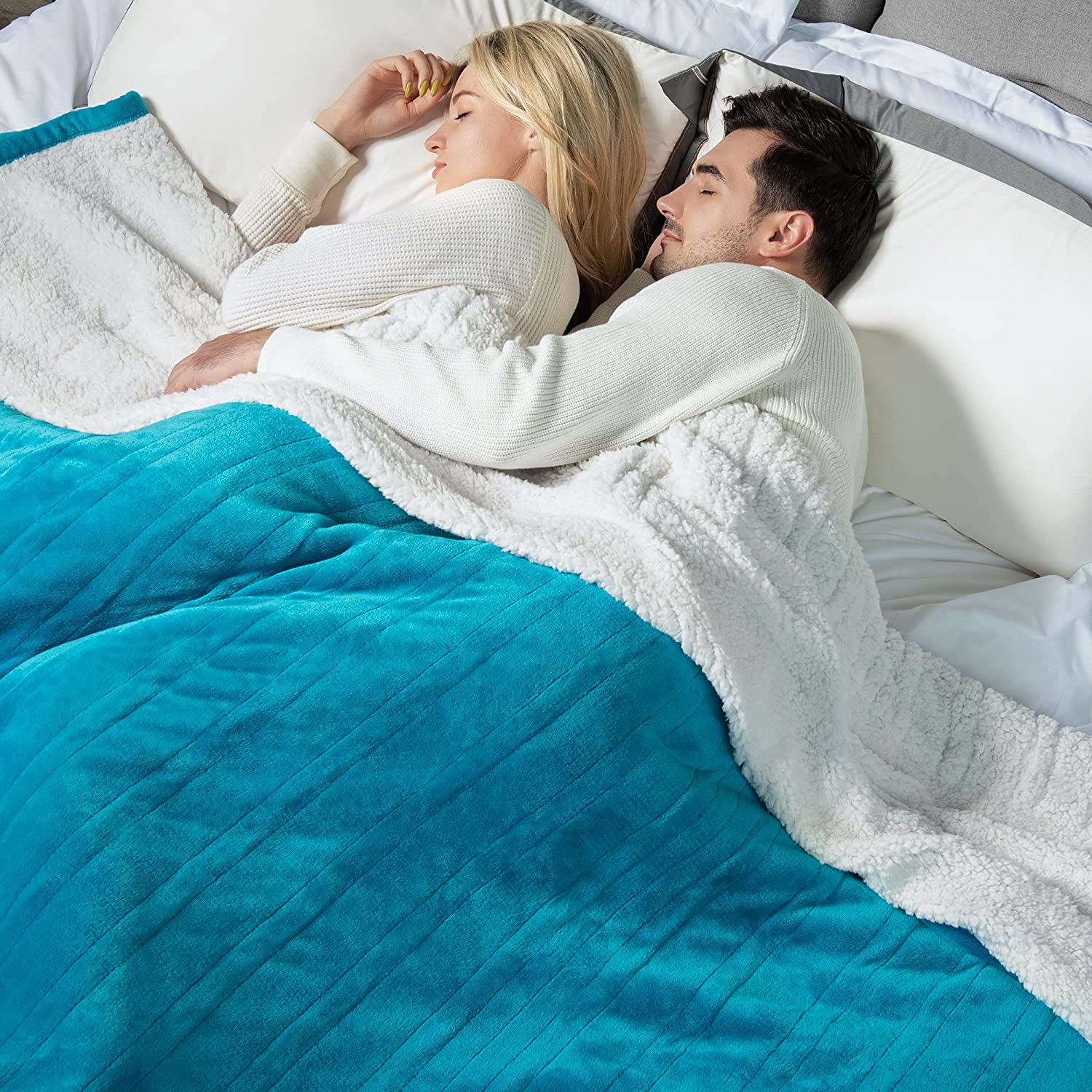A staged bedroom image on the exact WOOMER King page shows the Teal blanket across two sleepers