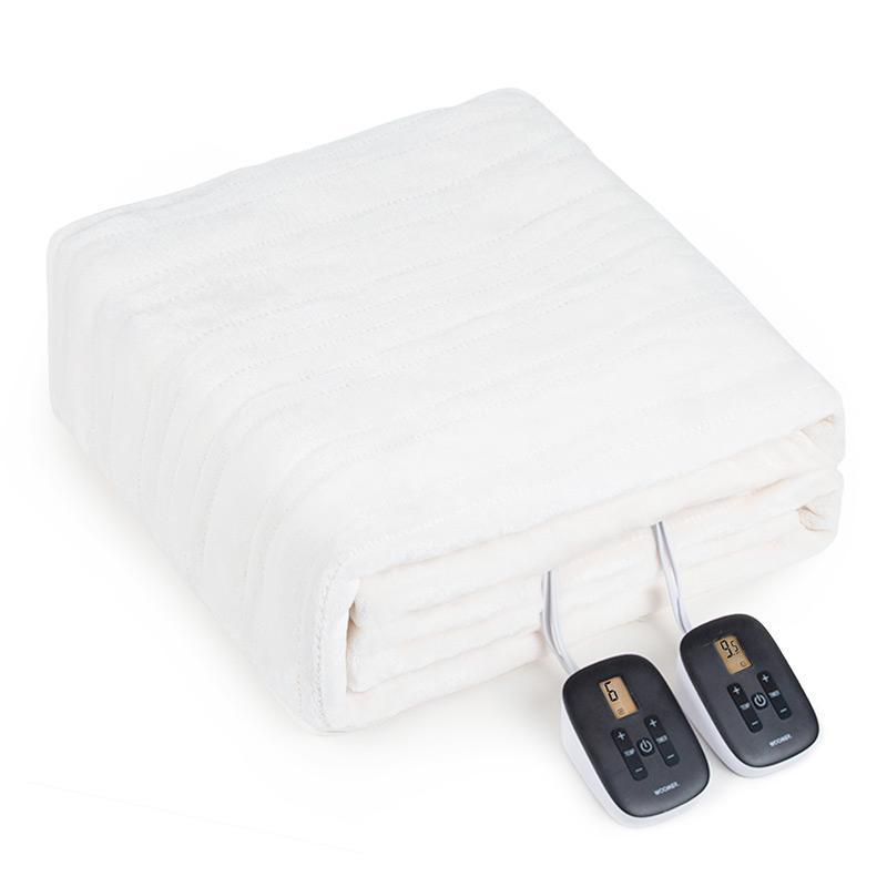 White WOOMER electric blanket folded with two wired control units beside it